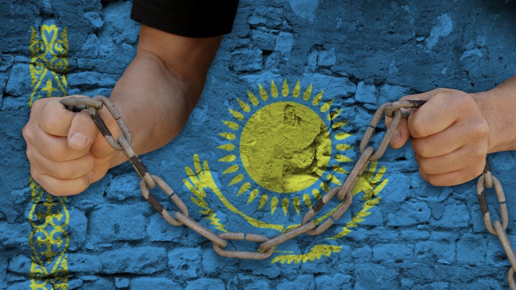male hands break the iron chain, a symbol of bondage,protest against the background of the national flag of Kazakhstan, the concept of political repression, arrest, crime, civil rights, freedom