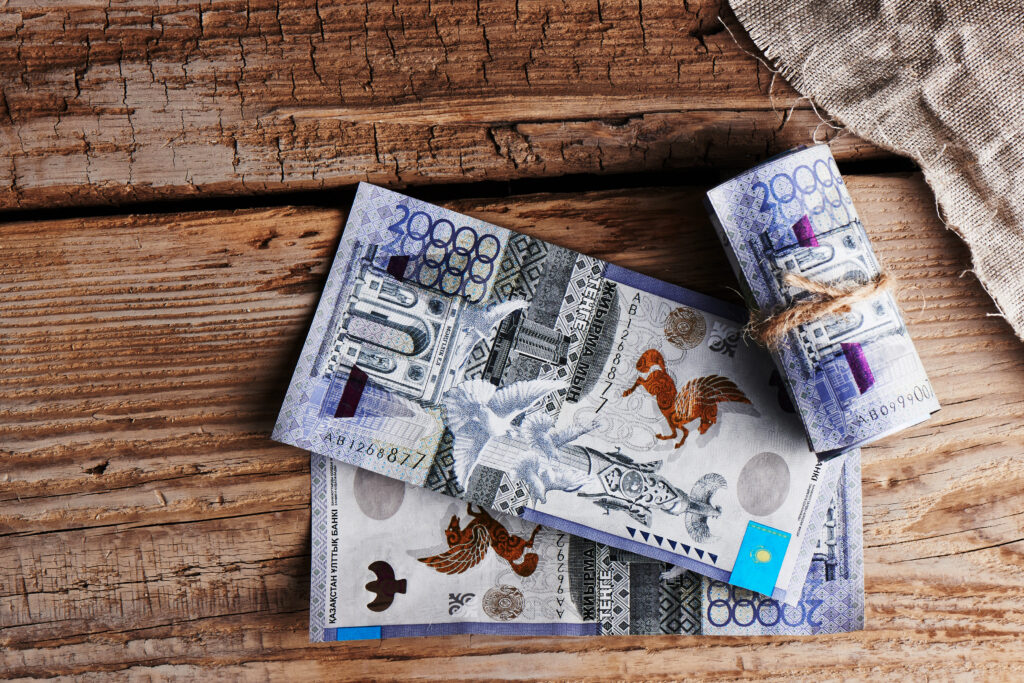 Tenge. Kazakhstan paper money on a wooden background.