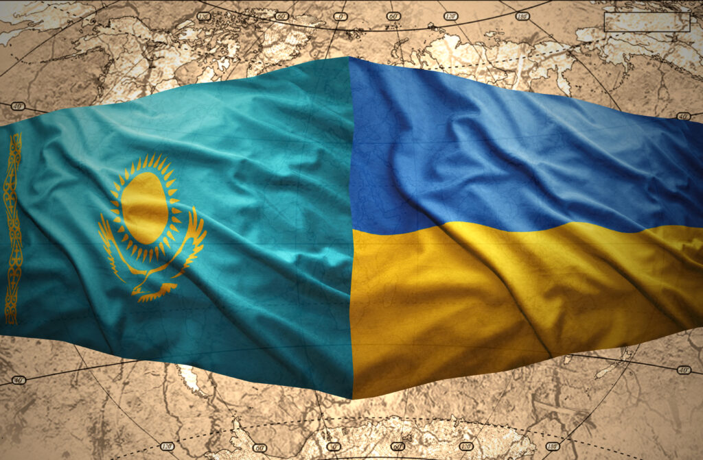 Waving Kazakh and Ukrainian flags of the political map of the world