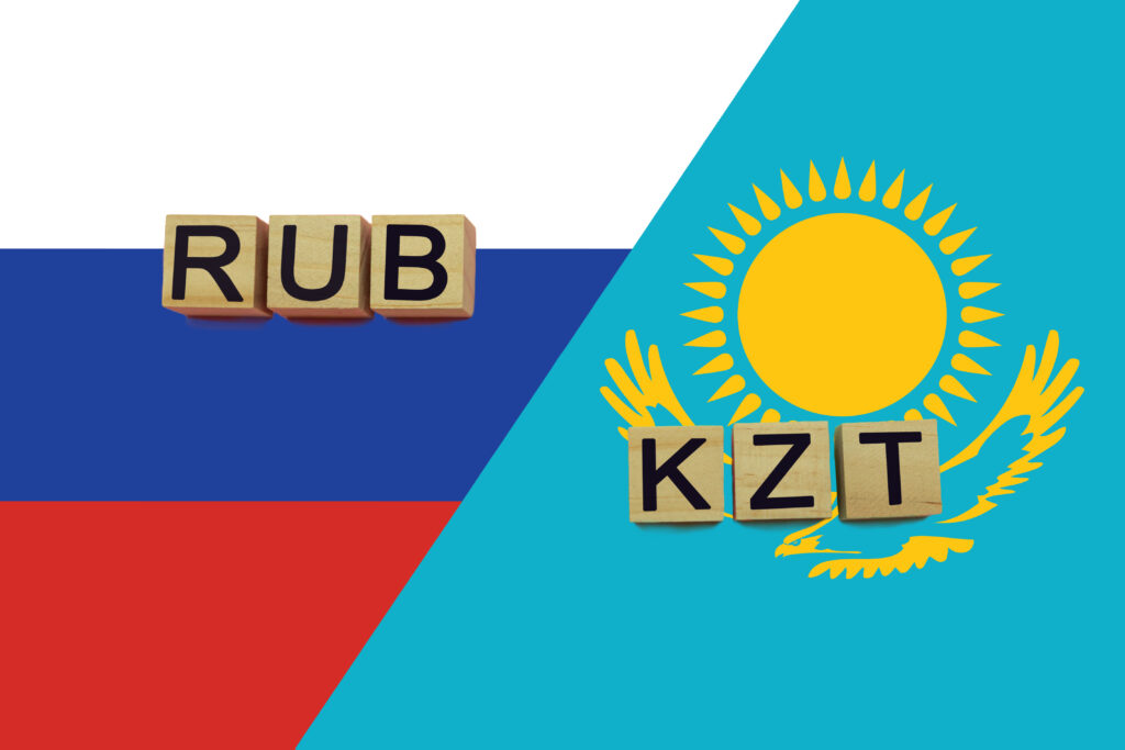 Russia and Kazakhstan currencies codes on national flags background. International money transfer concept