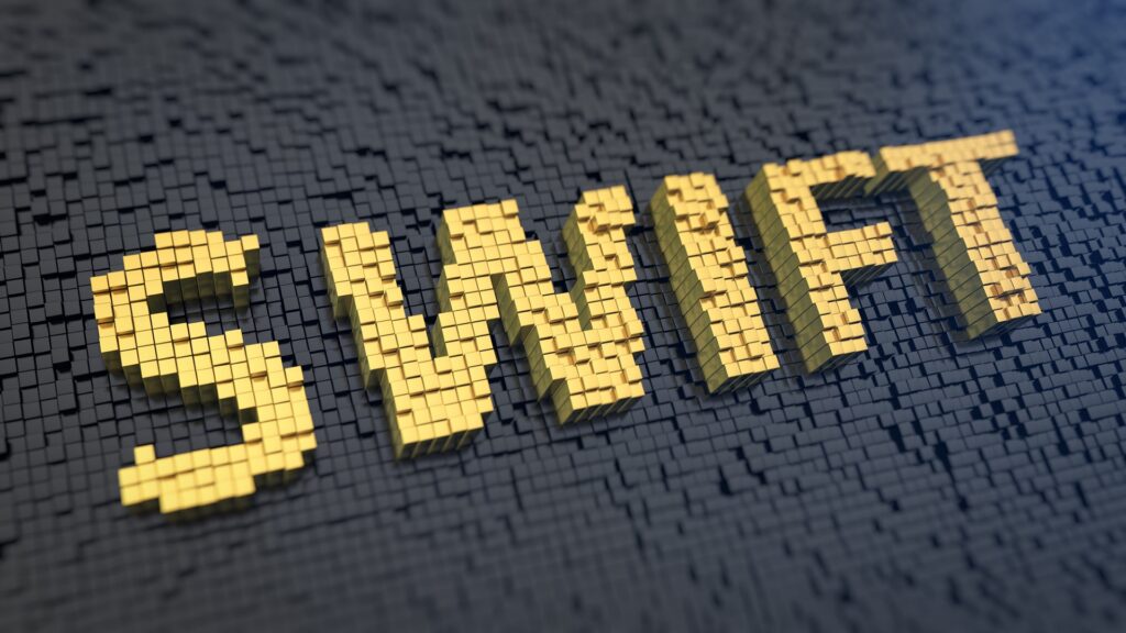 Acronym 'SWIFT' of the yellow square pixels on a black matrix background. Bank payment order system