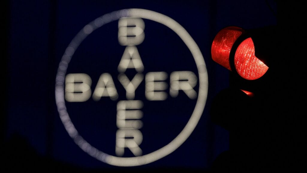 FILE PHOTO: The 120 metres high Bayer Cross, logo of German pharmaceutical and chemical maker Bayer AG, consisting of 1710 LED glass bulbs, is seen next to a red traffic light in Leverkusen, Germany, September 23, 2023.  REUTERS/Wolfgang Rattay/File Photo