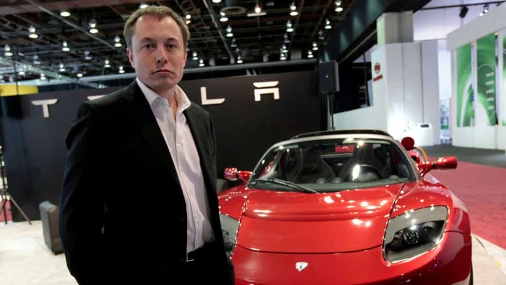 Tesla Motors Inc. CEO and Chairman Elon Musk stands in front of the Tesla Roadster electric vehicle as he addresses the media during press days of the North American International Auto Show in Detroit, Michigan January 13, 2009.  REUTERS/Rebecca Cook/