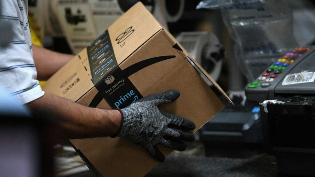 FILE PHOTO: A worker assembles a box for delivery at the Amazon fulfillment center in Baltimore, Maryland, U.S., April 30, 2019. REUTERS/Clodagh Kilcoyne/File Photo
