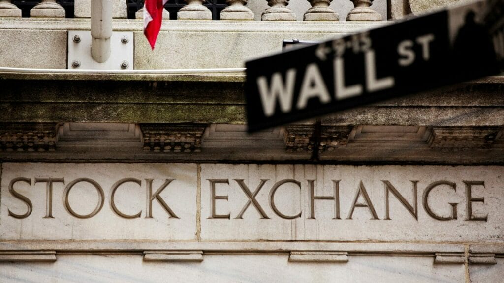 FILE PHOTO: A street sign for Wall Street hangs in front of the New York Stock Exchange May 8, 2013. REUTERS/Lucas Jackson//File Photo