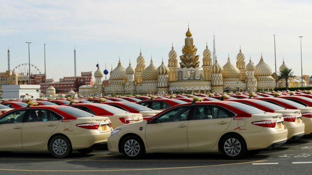 FILE PHOTO: Dubai Taxis that belong to the road transportation authority (RTA), are seen parked during the 24 hour lockdown to counter the coronavirus (Covid-19) outbreak in front of Dubai Global village, in Dubai, United Arab Emirates April 6, 2020. REUTERS/Ahmed Jadallah/File Photo