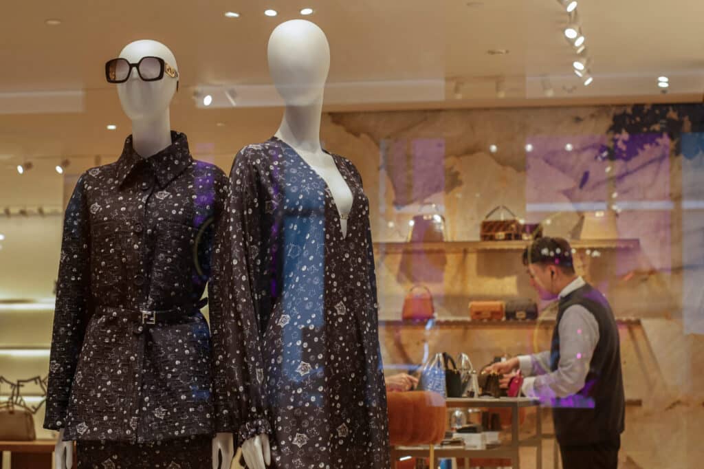 A luxury store employee introduces handbag styles to a customer (not pictured) in Tsim Sha Tsui, a bustling shopping hotspot, in Hong Kong, China December 5, 2023. REUTERS/Tyrone Siu