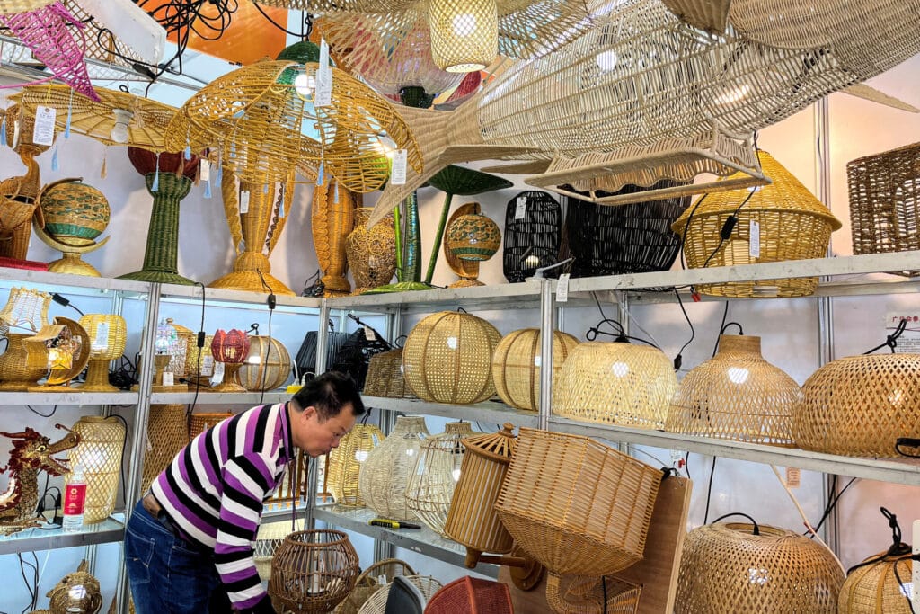 FILE PHOTO: A man works at his booth for lighting products at the China Import and Export Fair, also known as Canton Fair, in Guangzhou, Guangdong province, China April 15, 2023. REUTERS/Ellen Zhang/File Photo