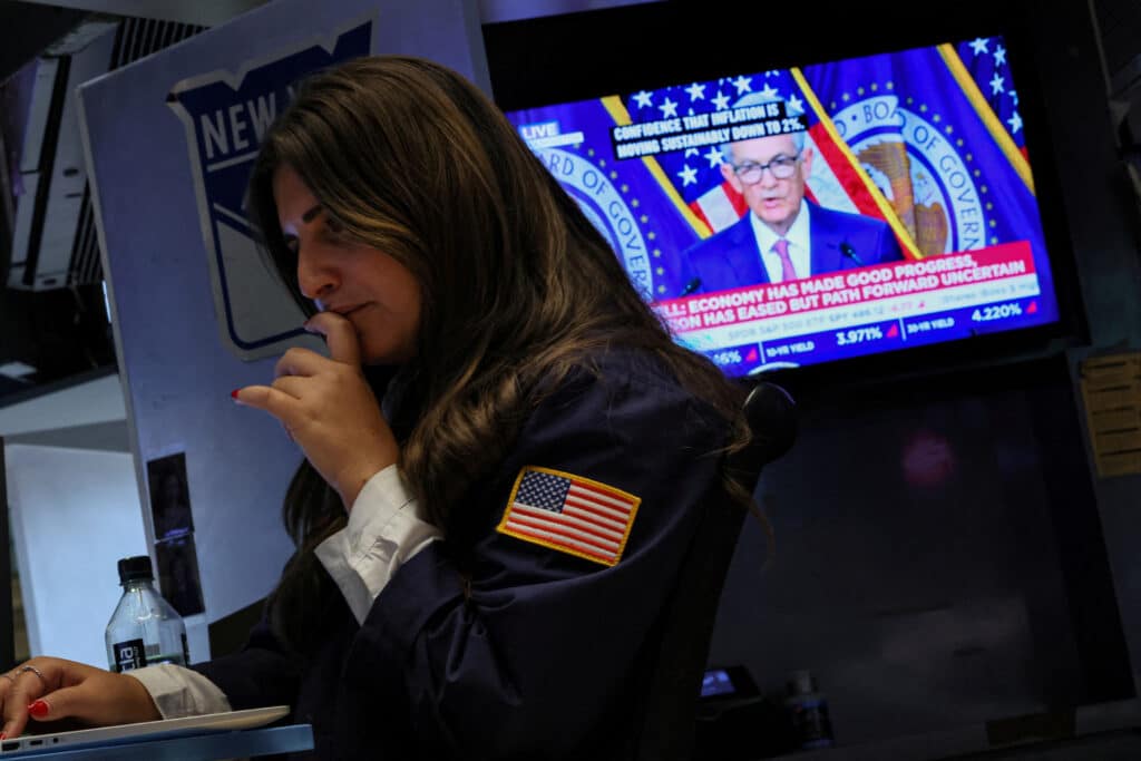 FILE PHOTO: A trader works, as a screen displays a news conference by Federal Reserve Board Chairman Jerome Powell following the Fed rate announcement, on the floor of the New York Stock Exchange (NYSE) in New York City, U.S., January 31, 2024.  REUTERS/Brendan McDermid/File Photo