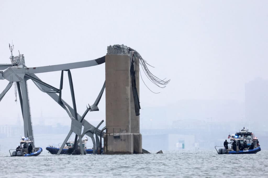 Emergency boats work near the collapsed section of the Francis Scott Key Bridge, after the Dali cargo vessel crashed into it, in Baltimore, Maryland, U.S., March 27, 2024. REUTERS/Mike Segar     TPX IMAGES OF THE DAY
