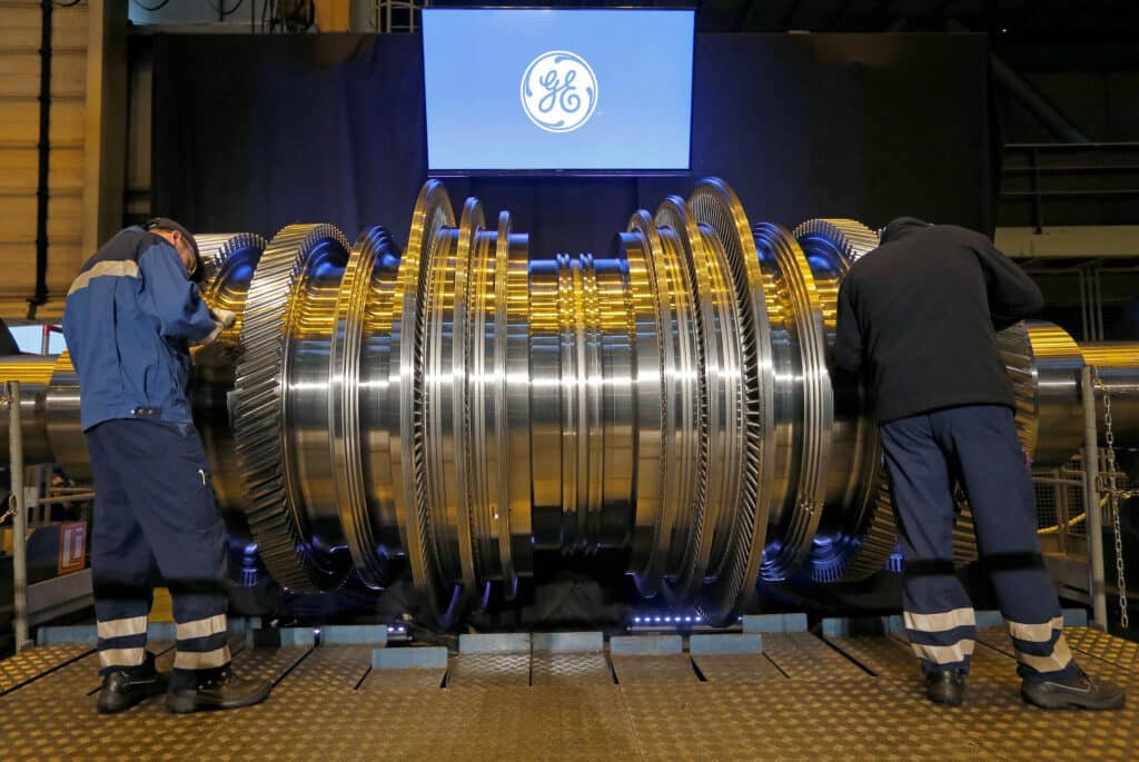 FILE PHOTO: Employees work on a turbine at the General Electric plant in Belfort, France, February 22, 2017. REUTERS/Vincent Kessler/File Photo