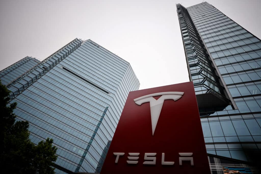 FILE PHOTO: A Tesla logo is seen outside a showroom of the carmaker in Beijing, China May 31, 2023. REUTERS/Thomas Peter/File Photo