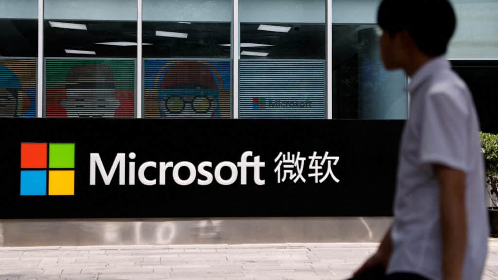 FILE PHOTO: A person walks past a Microsoft sign at its office building in Beijing, China May 25, 2023. REUTERS/Tingshu Wang/File Photo