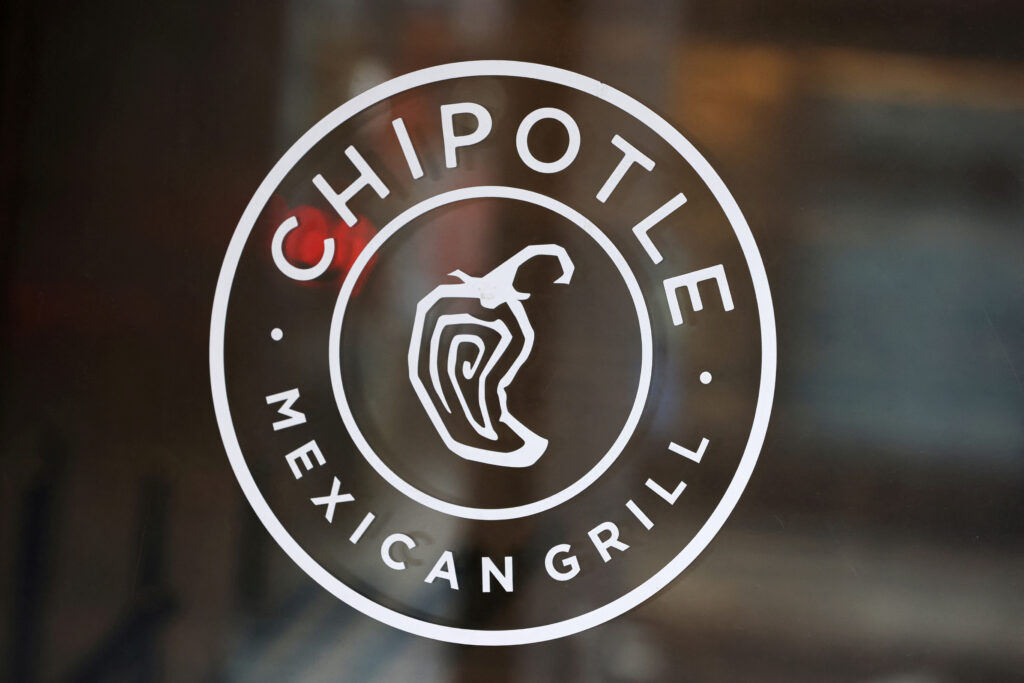 FILE PHOTO: The logo of Chipotle is seen on one of their restaurants in Manhattan, New York City, U.S., February 7, 2022. REUTERS/Andrew Kelly/File Photo