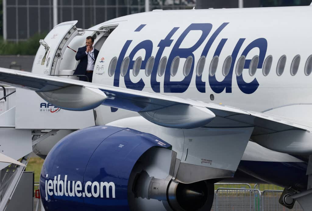 FILE PHOTO: Branding for JetBlue Airlines is seen at the Farnborough International Airshow, in Farnborough, Britain, July 22, 2024. REUTERS/Toby Melville/File Photo