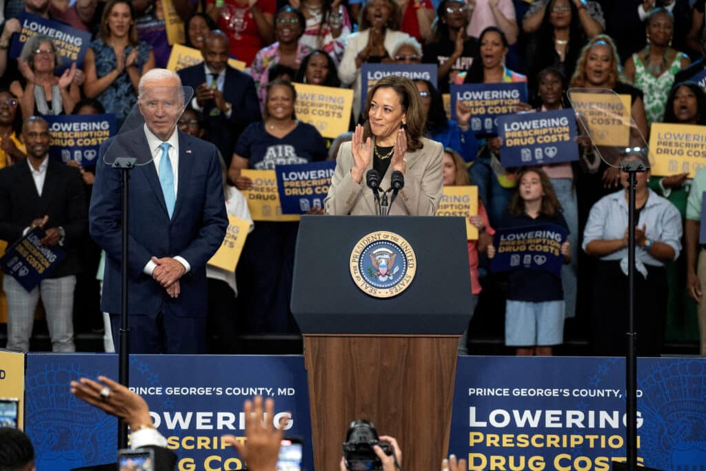 FILE PHOTO: Vice President and Democratic presidential candidate Kamala Harris, delivers remarks as U.S. President Joe Biden looks on at an event on Medicare drug price negotiations, in Prince George's County, Maryland, U.S., August 15, 2024. REUTERS/Ken Cedeno/File Photo