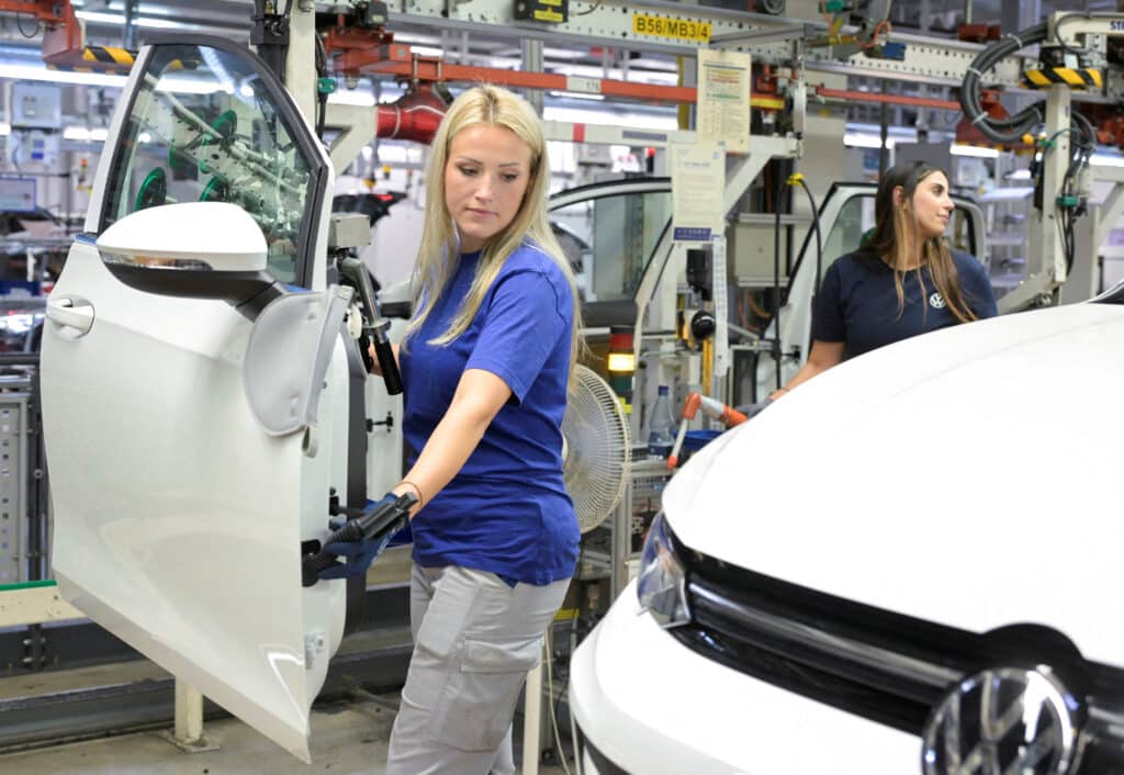 FILE PHOTO: Volkswagen employee works on a production line for the Golf VIII and Tiguan cars at the VW headquarters in Wolfsburg, Germany May 23, 2024. REUTERS/Fabian Bimmer/File Photo