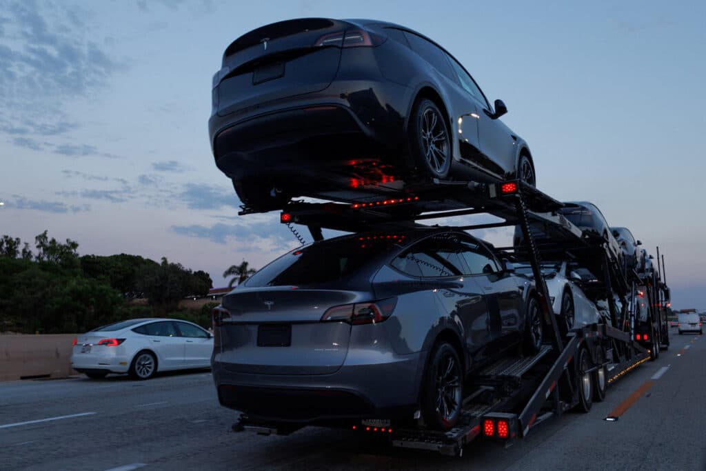 Newly manufactured Tesla Model Y SUV vehicles are transported along a freeway near Carlsbad, California, U.S., September 9, 2024.     REUTERS/Mike Blake