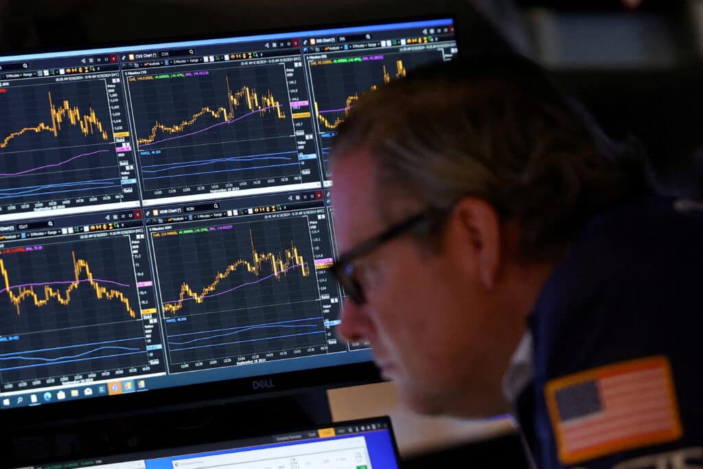 FILE PHOTO: A trader works on the trading floor at The New York Stock Exchange (NYSE) following the Federal Reserve rate announcement, in New York City, U.S., September 18, 2024. REUTERS/Andrew Kelly/File Photo