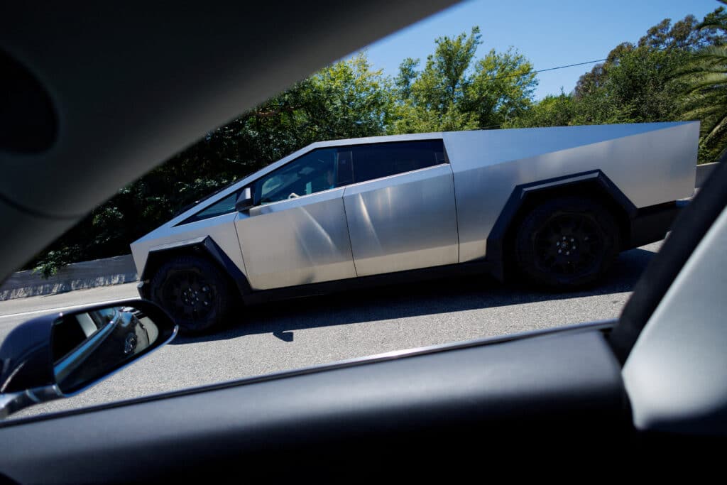 FILE PHOTO: A Tesla Cybertruck is driven along a freeway in Los Angeles, California, U.S. June 21, 2024.  REUTERS/Mike Blake/File Photo