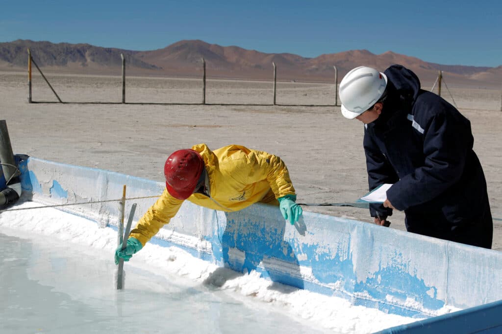 FILE PHOTO: Technicians from the Orocobre mining company work on an evaporation pond test in the salt flat at Olaroz, 4,000 meters (13,123 feet) above sea level and north of the Argentine province of San Salvador de Jujuy August 7, 2010.  Orocobre's assets are now part of Arcadium Lithium, which global miner Rio Tinto wants to buy.  Picture taken on August 7, 2010. REUTERS/Enrique Marcarian/File Photo