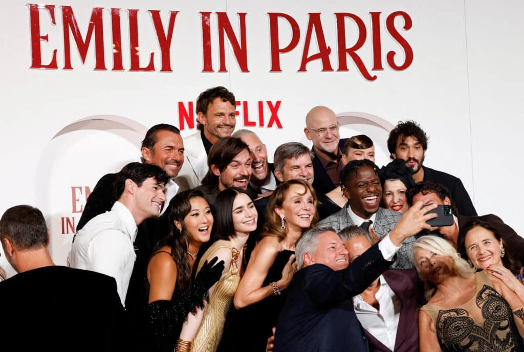 FILE PHOTO: Ashley Park, Lily Collins, Philippine Leroy-Beaulieu, William Abadie, Lucas Bravo, Bruno Gouery and Samuel Arnold pose for a selfie as they attend the European premiere for Netflix's "Emily In Paris" Season 4 at the Moderno cinema in Rome, Italy, September 10, 2024. REUTERS/Remo Casilli/File Photo