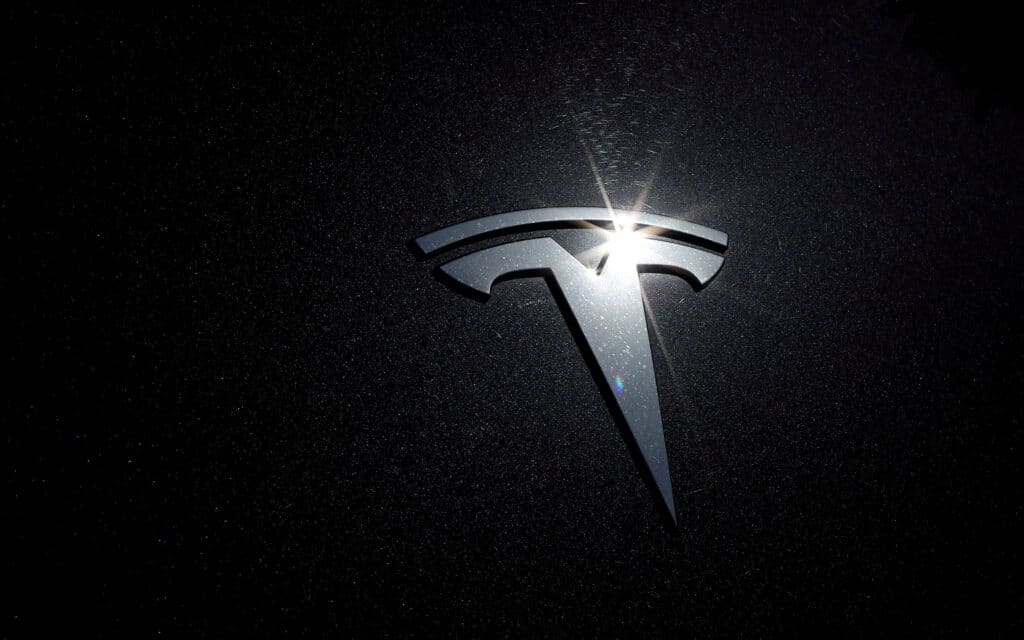 FILE PHOTO: The Tesla logo is seen on a car in Los Angeles, California, U.S., July 9, 2020.  REUTERS/Lucy Nicholson/File Photo