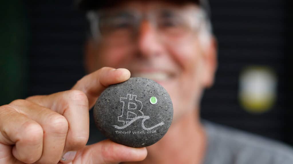 Wayne Gregory shows an engraved rock with Bitcoin sign during the launch of Adopting Bitcoin 2024 – The high signal Bitcoin conference for builders, in Nuevo Cuscatlan, El Salvador, November 15, 2024. REUTERS/Jose Cabezas