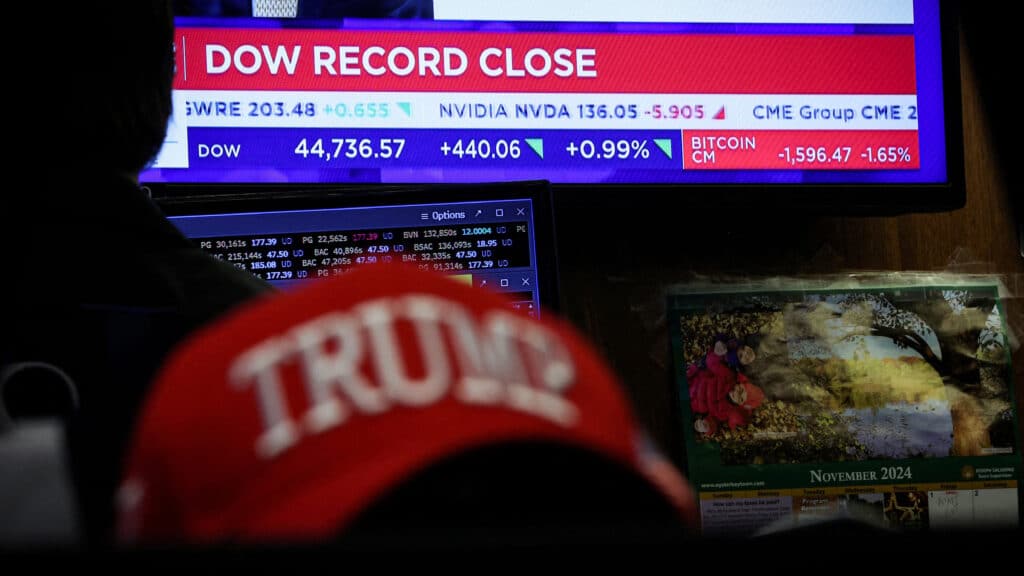 FILE PHOTO: A screen displays the Dow Jones Industrial Average after the closing bell on the floor at the New York Stock Exchange (NYSE) in New York City, U.S., November 25, 2024.  REUTERS/Brendan McDermid/File Photo