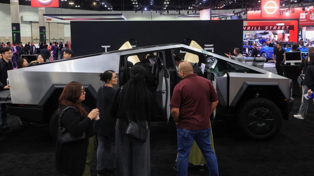 Visitors view a Tesla Cybertruck on display at the Los Angeles Auto Show, in Los Angeles, California, U.S., November 21, 2024. REUTERS/David Swanson