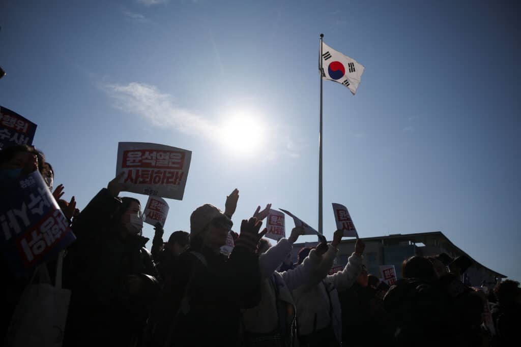 Protesters hold up signs as people and lawmakers attend a rally to condemn South Korean President’s surprise declarations of the martial law last night and to call for his resignation, at the national assembly in Seoul, South Korea, December 4, 2024. REUTERS/Kim Hong-Ji