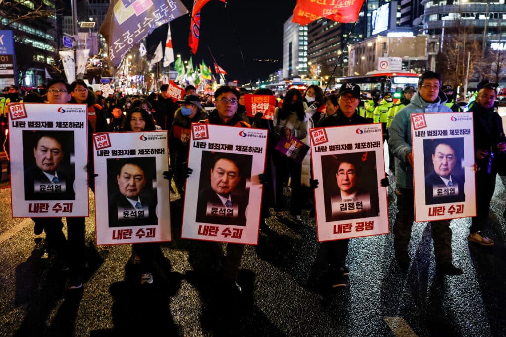 Protesters hold placards during a candlelight vigil to condemn South Korean President Yoon Suk Yeol's surprise declarations of the failed martial law and to call for his resignation in Seoul, South Korea, December 5, 2024. REUTERS/Kim Kyung-Hoon