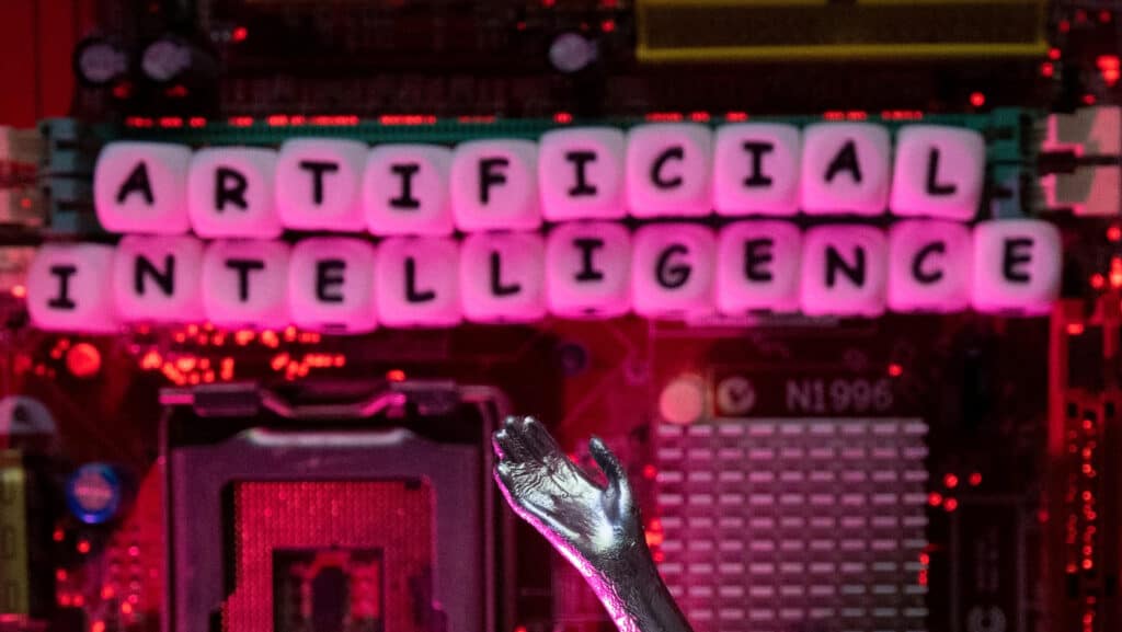 FILE PHOTO: AI (Artificial Intelligence) letters and robot hand are placed on computer motherboard in this illustration taken, June 23, 2023. REUTERS/Dado Ruvic/Illustration/File Photo