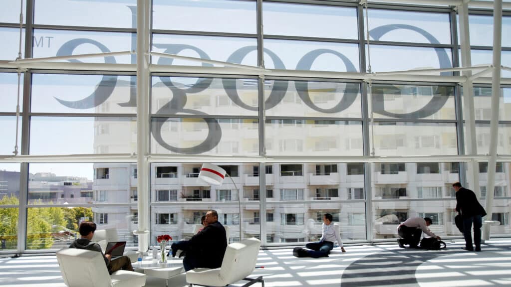 FILE PHOTO: Attendees sits in front of a Google logo during Google I/O Conference at Moscone Center in San Francisco, California June 28, 2012. REUTERS/Stephen Lam/File Photo