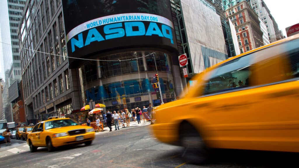 FILE PHOTO: Taxi cabs drive past the Nasdaq MarketSite in New York's Times Square, August 23, 2013. REUTERS/Andrew Kelly/File Photo
