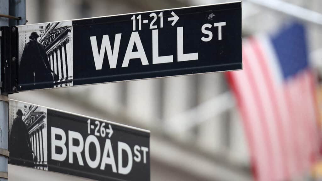 FILE PHOTO: A Wall Street sign hangs in front of a U.S. Flag outside the New York Stock Exchange (NYSE) before the Federal Reserve announcement in New York City, U.S., September 18, 2024. REUTERS/Andrew Kelly/File Photo