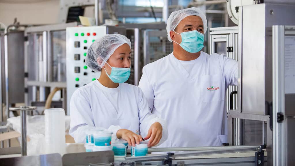 Almaty province, Kazakhstan - June 06, 2012: Amiran milk factory. Two operators on production line.