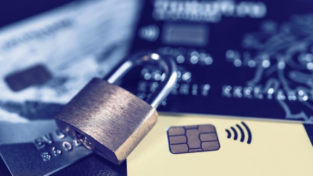 Debit or credit plastic card with lock. The concept of security, protection or blocking of funds on the card.