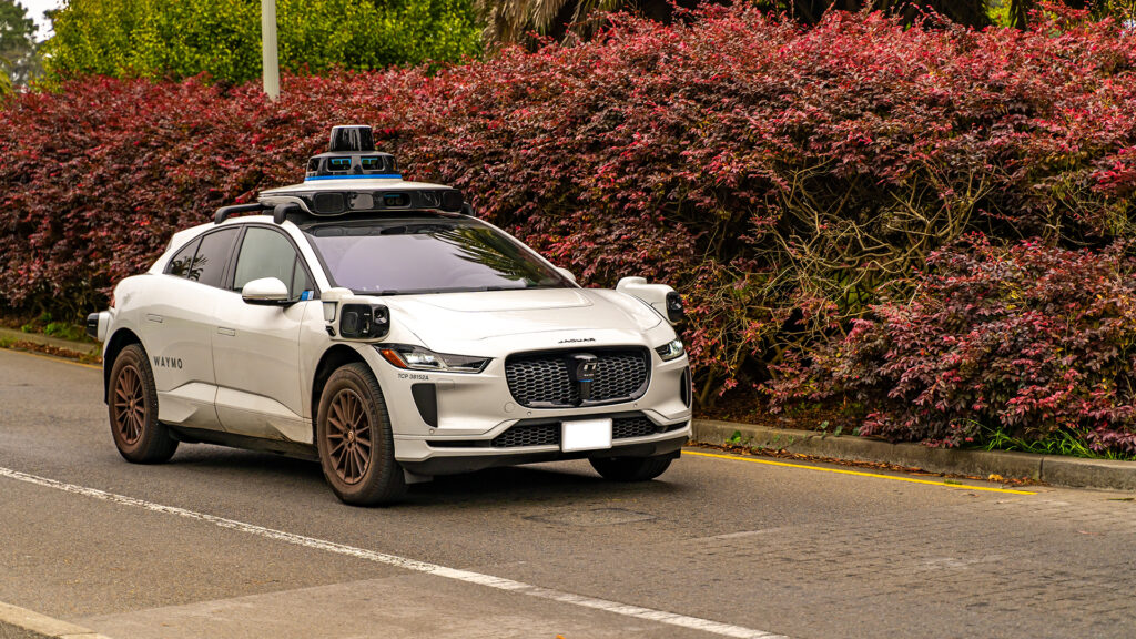 San Francisco, CA, USA - September 21, 2024: Waymo self driving taxi driving in downtown San Francisco