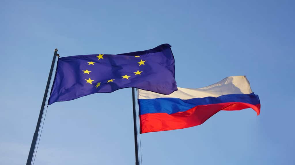 European Union -  EU -  and Russian Federation flags on background of blue sky. Europa and Russia.