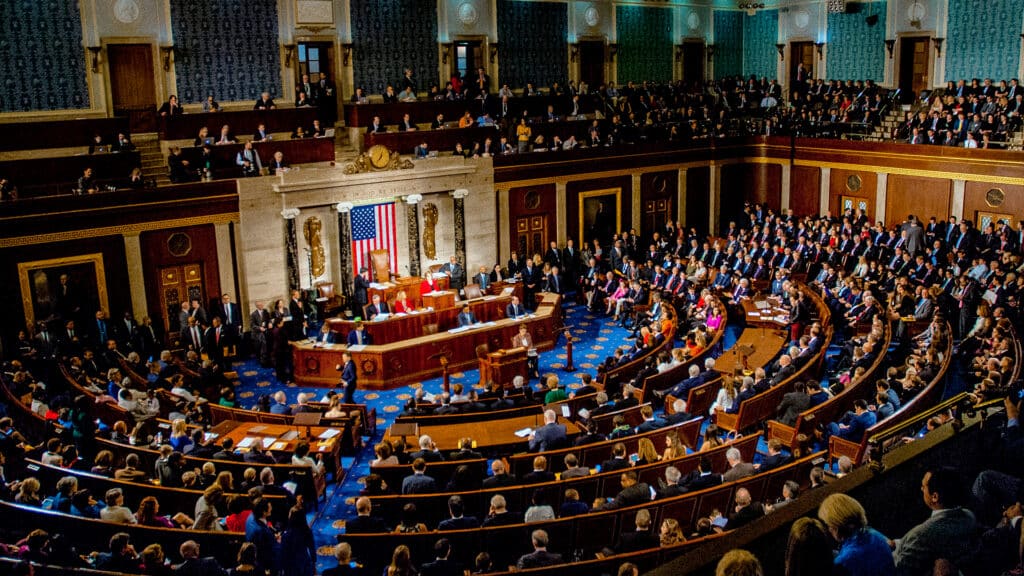 Members of the U.S. House of Representatives gather in the chamber during a legislative session