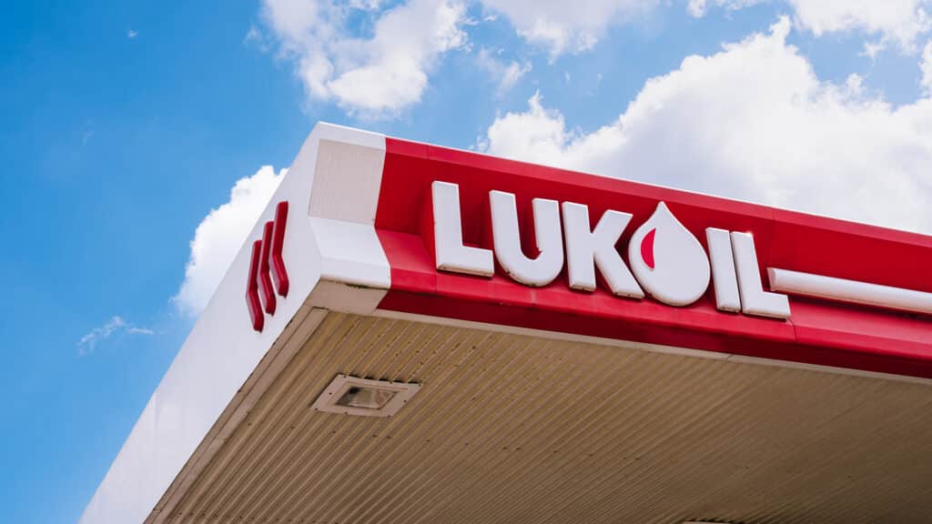 Antwerp, Belgium, May 26, 2022 - A fuel station with LUKOIL brand red signage and an oil drop symbol against a blue sky, energy industry